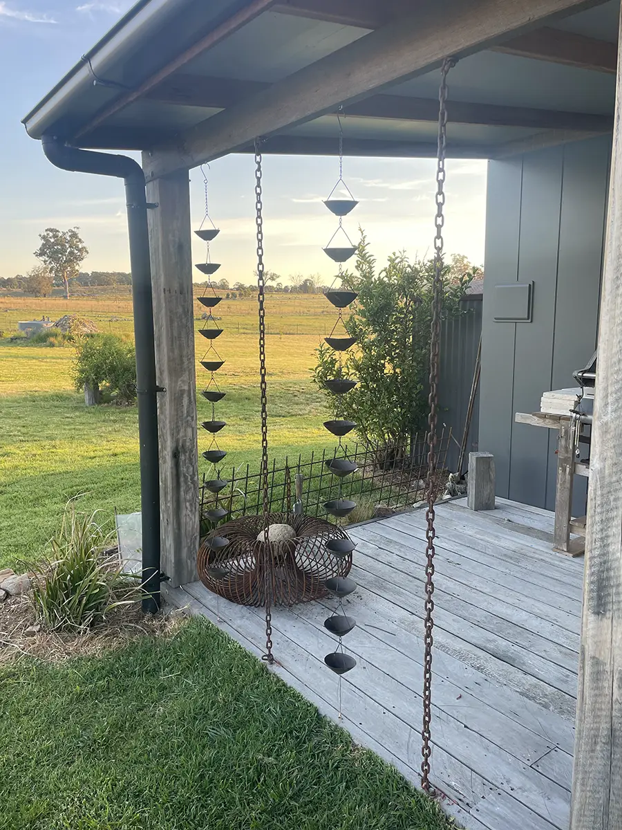 Deck with decorative rain chains at sunset